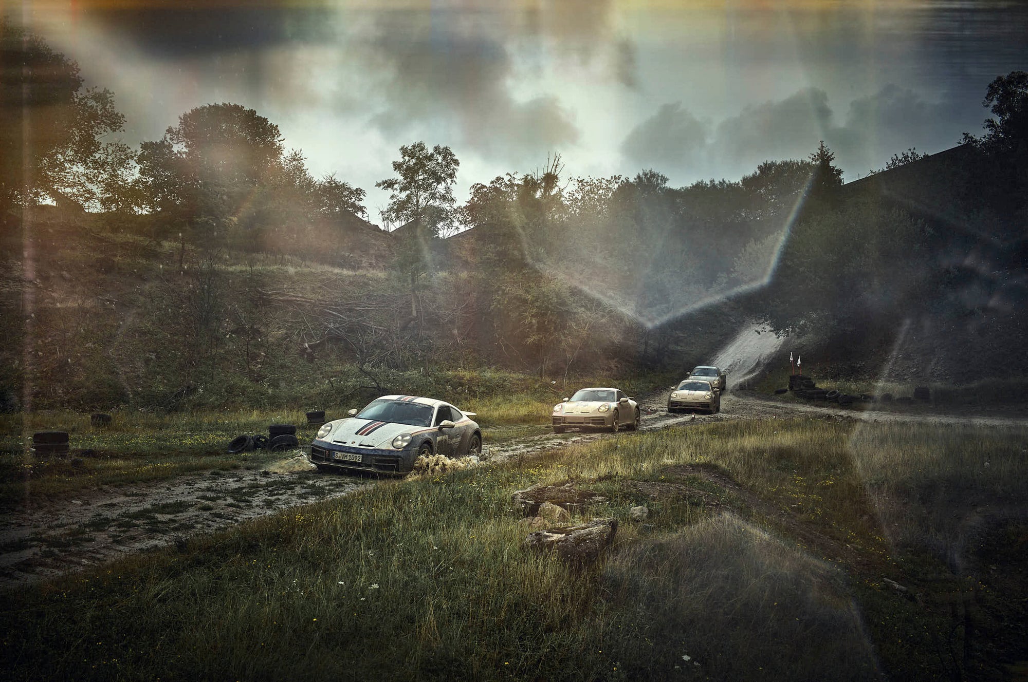 Fine art photography by Frank Kayser – four Porsche Dakar cars riding together, kicking up clouds of dust.