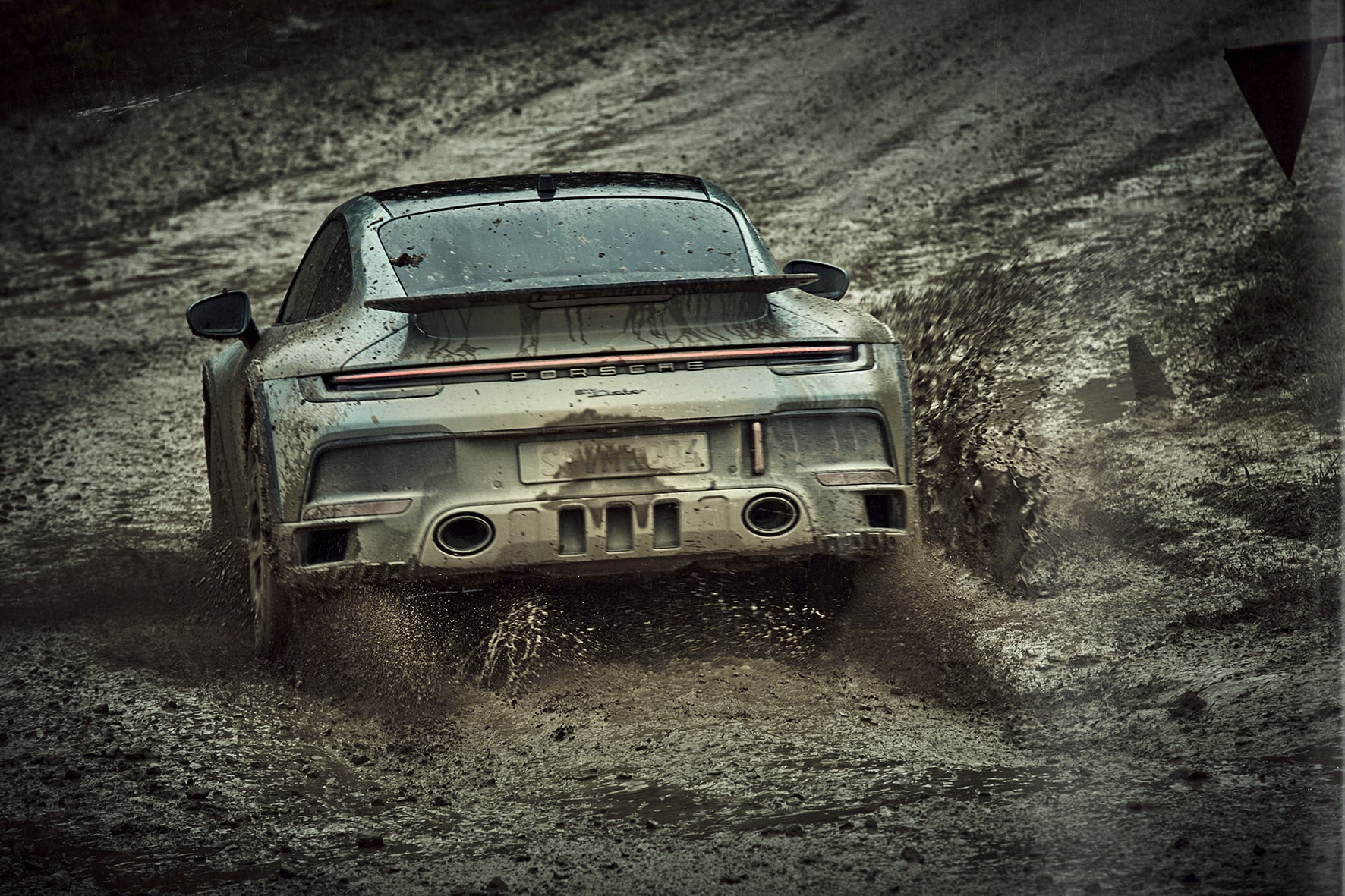 Fine art photo by Frank Kayser – Porsche 911 Dakar rear view throwing mud in dramatic spray.