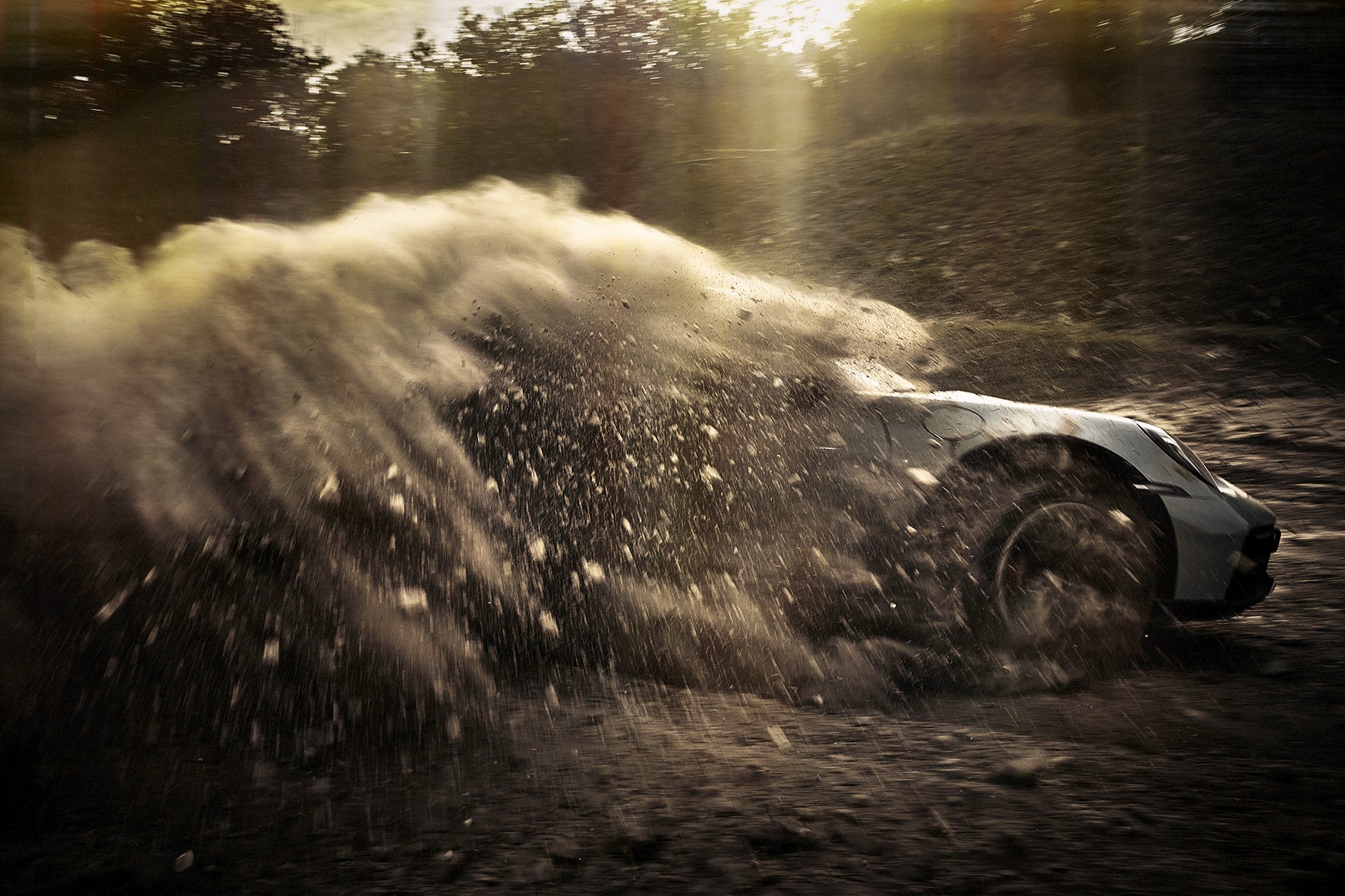 Fine art photography by Frank Kayser – Porsche 911 Dakar engulfed in a dramatic spray of dirt and stones.
