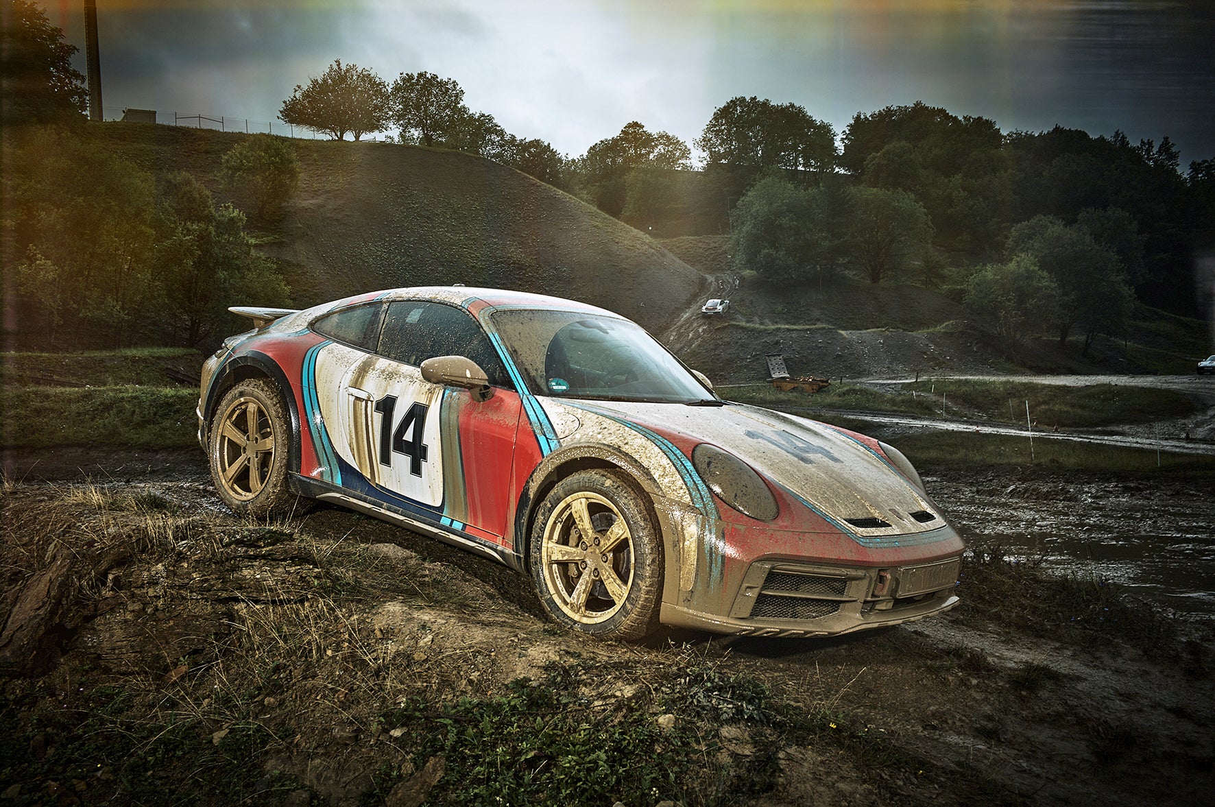 beauty shot of a Porsche 911 Dakar sitting on a hill
