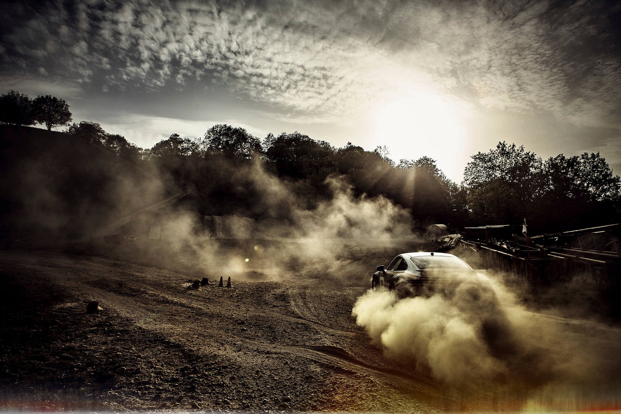 nice landscape of an offroad drifting Porsche 911 Dakar