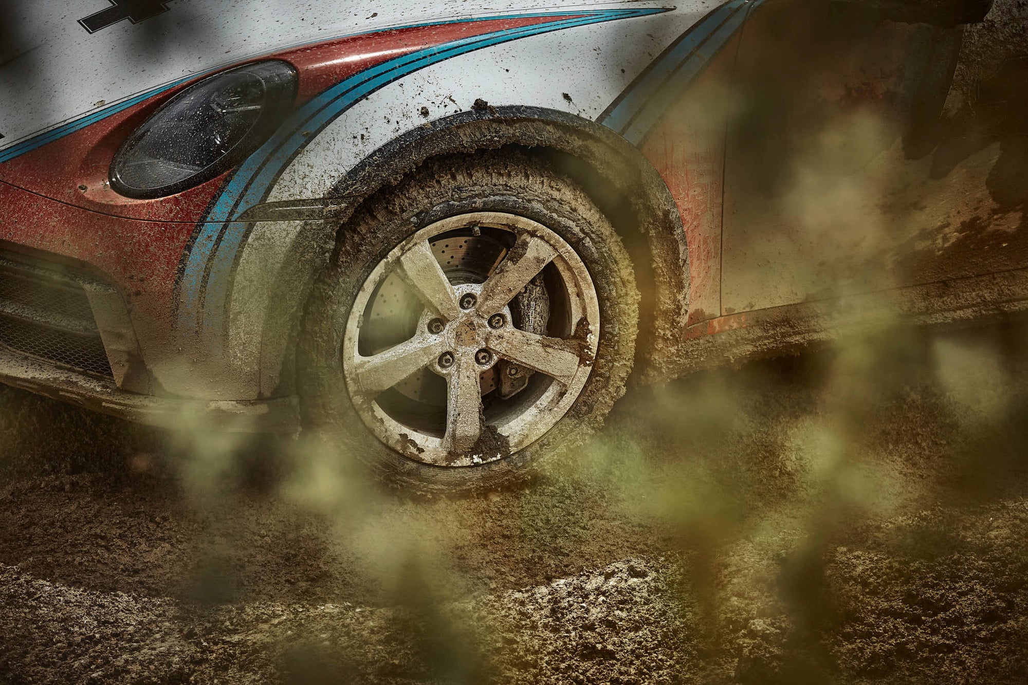 a very muddy Porsche wheel 