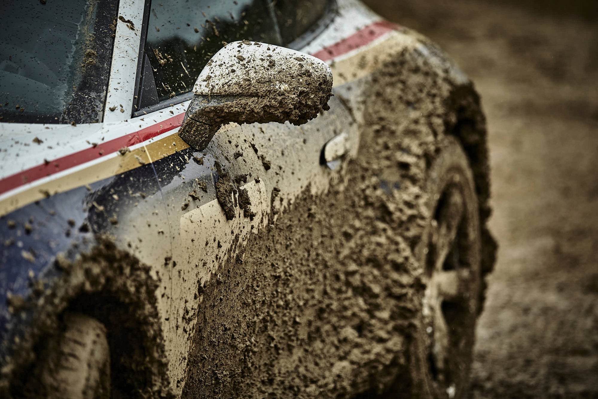 a Porsche 911 Dakar after a muddy ride